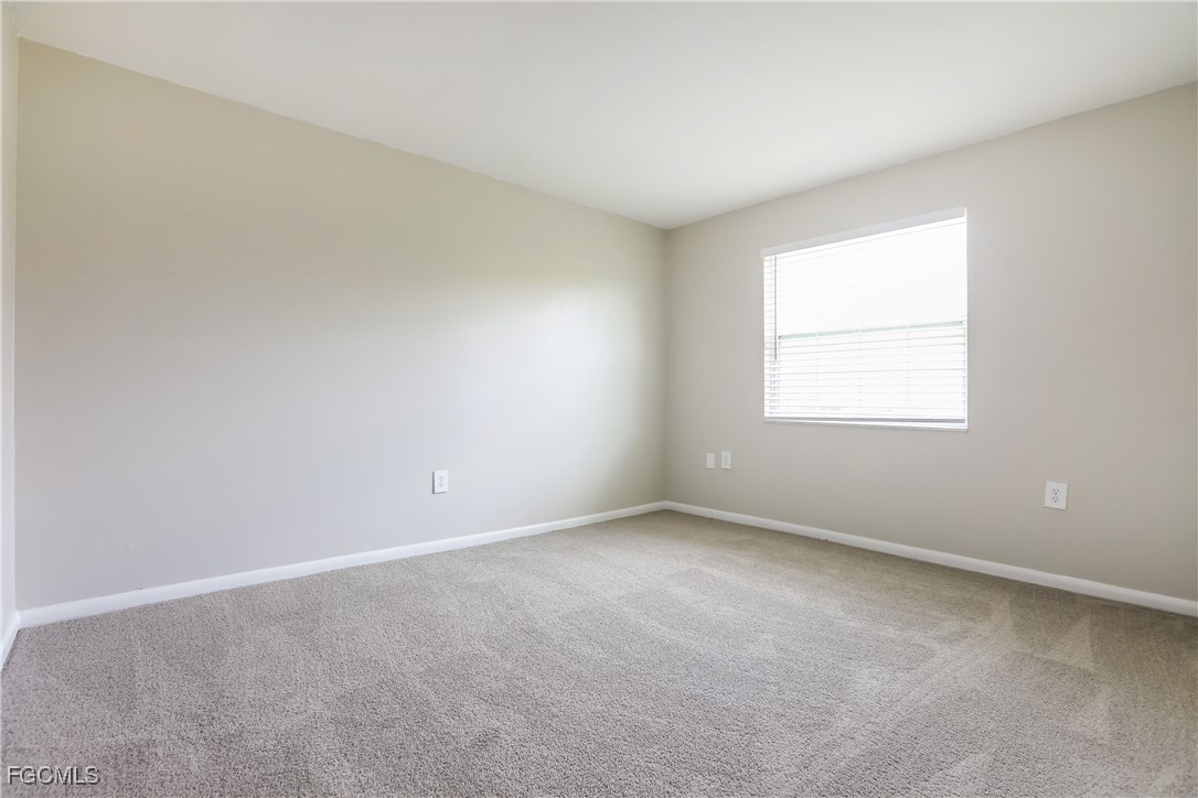 64 Golfview Road Rotonda West, FL 33947 - Photo 12 of 16 an empty room with a window