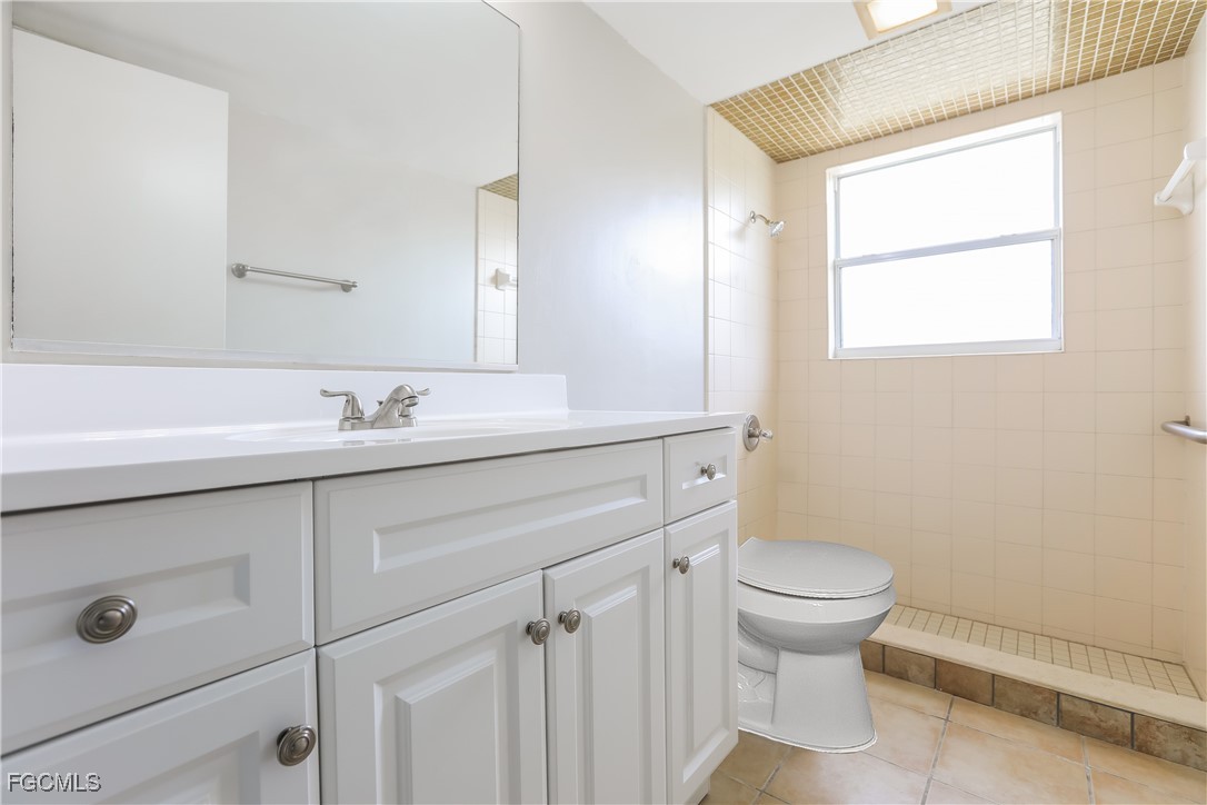 64 Golfview Road Rotonda West, FL 33947 - Photo 14 of 16 a bathroom with a sink toilet and a mirror