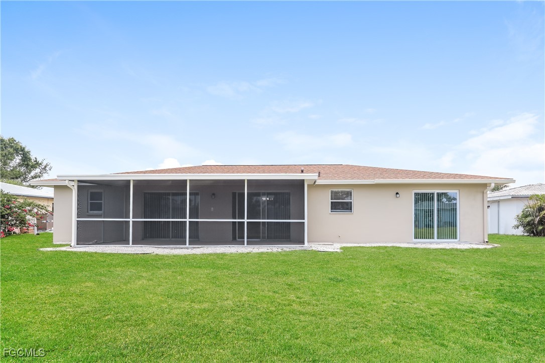 64 Golfview Road Rotonda West, FL 33947 - Photo 16 of 16 a view of house with a yard and large window