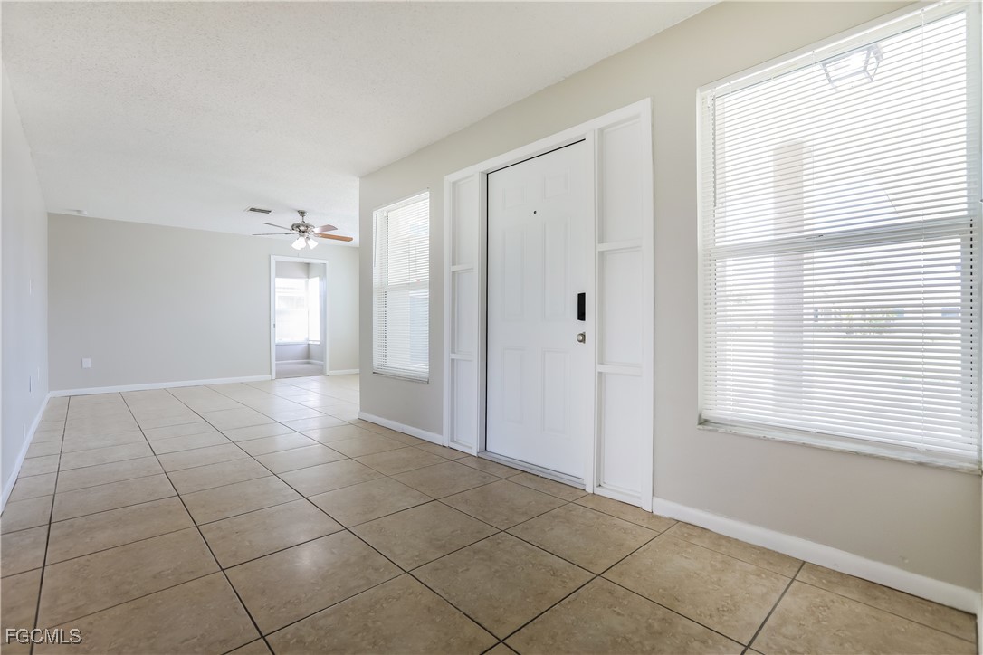 64 Golfview Road Rotonda West, FL 33947 - Photo 3 of 16 a view of an empty room with a window
