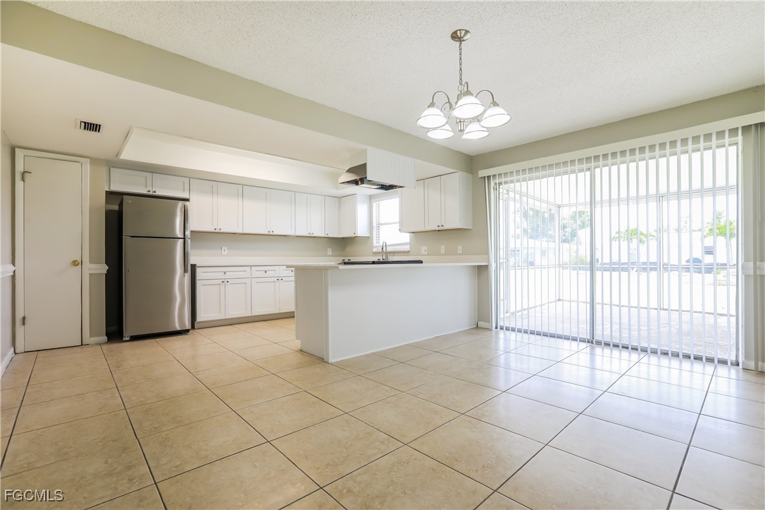 64 Golfview Road Rotonda West, FL 33947 - Photo 6 of 16 a large kitchen with a stove a refrigerator and a sink