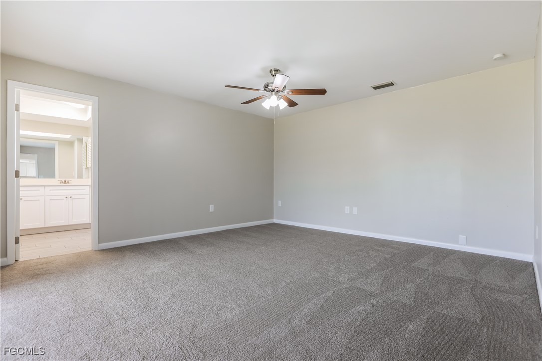 64 Golfview Road Rotonda West, FL 33947 - Photo 8 of 16 an empty room with a fan & a window