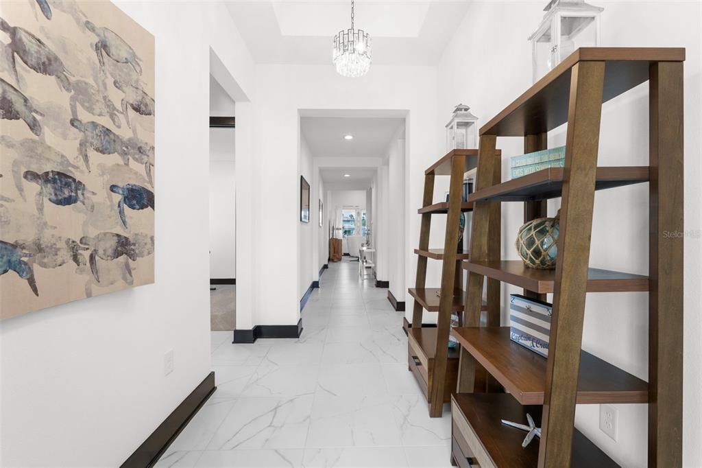 8756 Windlass Cove Palmetto, FL 34221 - Photo 12 of 50 a view of a hallway with wooden floor and stairs