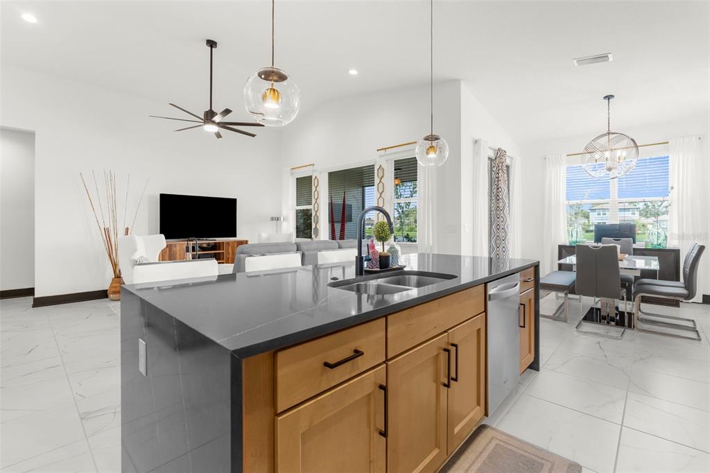 8756 Windlass Cove Palmetto, FL 34221 - Photo 14 of 50 a kitchen with stainless steel appliances a stove a sink and chairs
