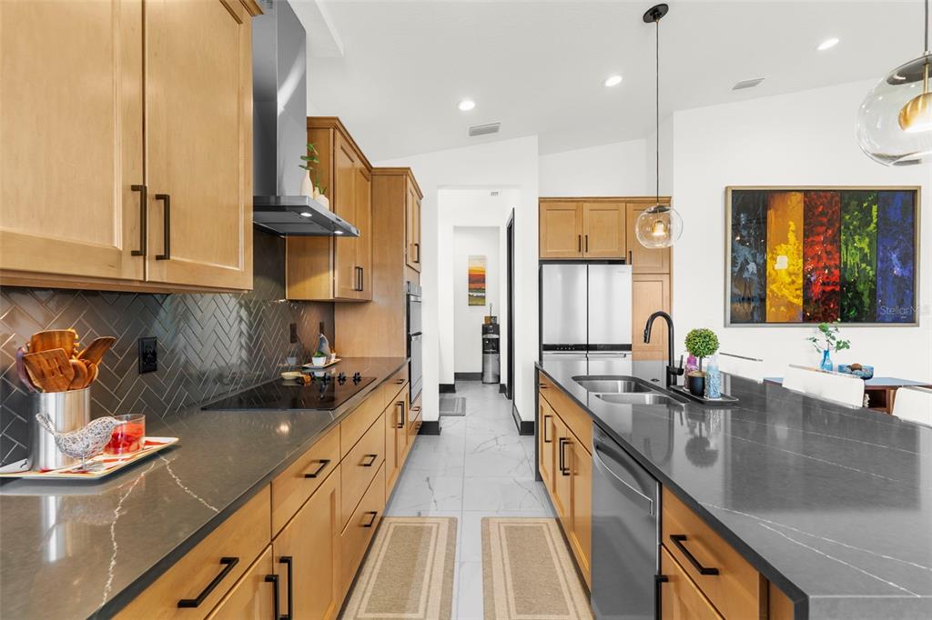 8756 Windlass Cove Palmetto, FL 34221 - Photo 15 of 50 a kitchen with stainless steel appliances granite countertop a sink stove and cabinets