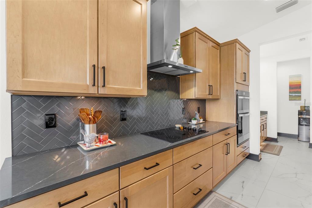 8756 Windlass Cove Palmetto, FL 34221 - Photo 16 of 50 a kitchen with stainless steel appliances granite countertop a stove and a white cabinets