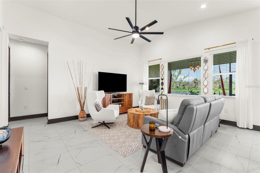 8756 Windlass Cove Palmetto, FL 34221 - Photo 26 of 50 a living room with furniture and a flat screen tv