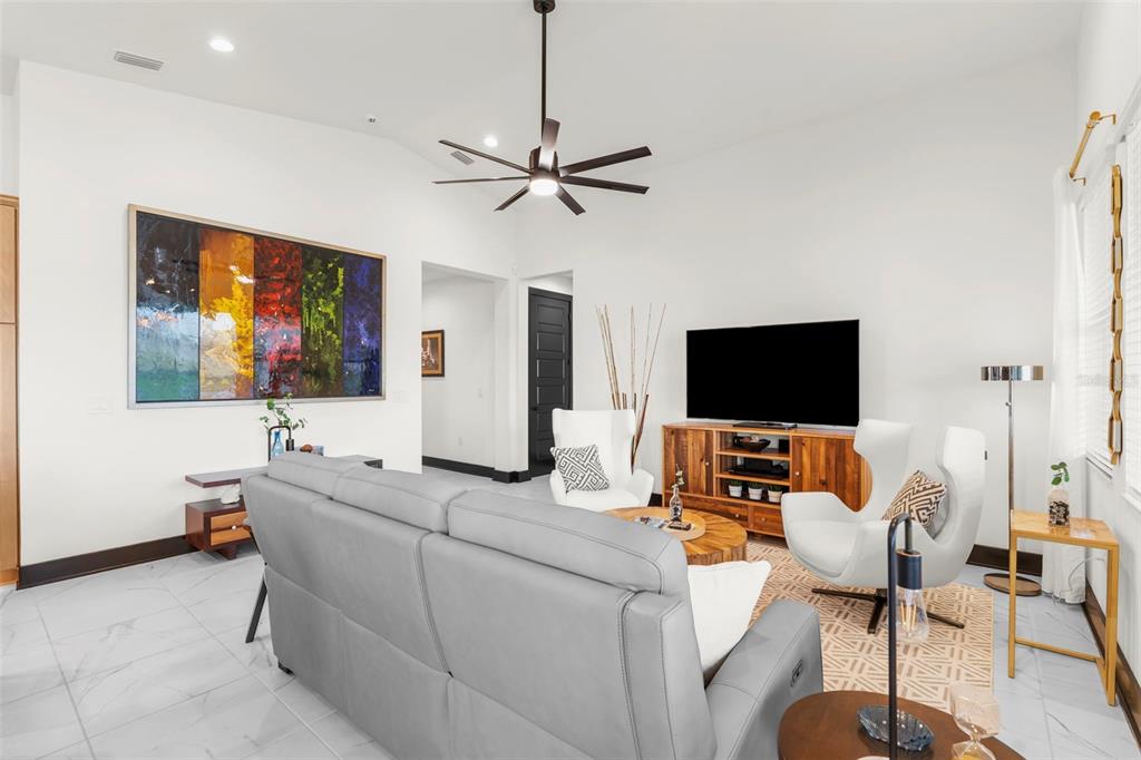 8756 Windlass Cove Palmetto, FL 34221 - Photo 27 of 50 a living room with furniture and a flat screen tv