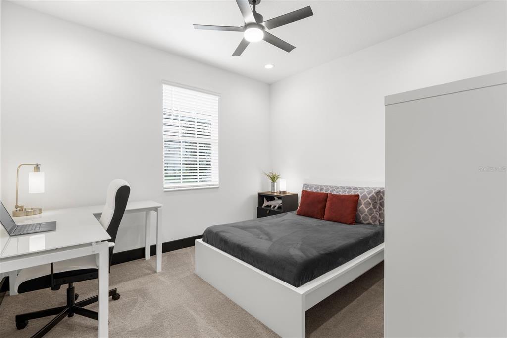 8756 Windlass Cove Palmetto, FL 34221 - Photo 28 of 50 a bedroom with a bed and a desk