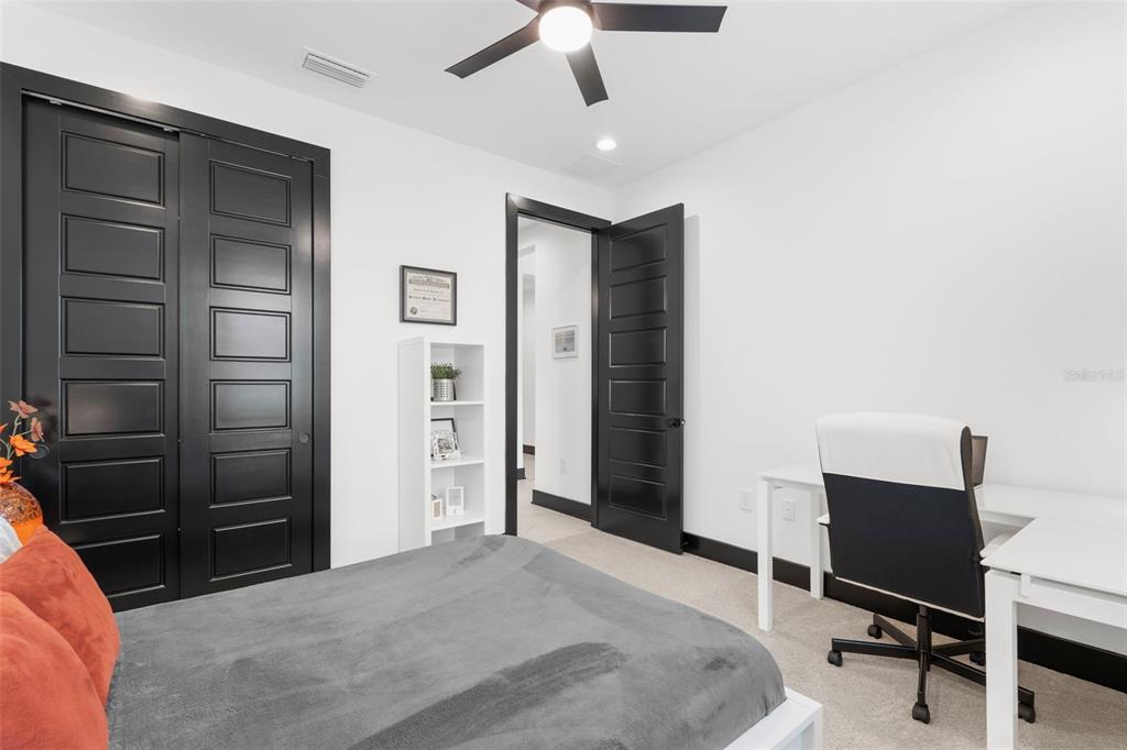 8756 Windlass Cove Palmetto, FL 34221 - Photo 29 of 50 a bedroom with a bed and a chandelier