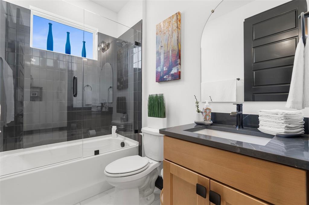 8756 Windlass Cove Palmetto, FL 34221 - Photo 30 of 50 a bathroom with a granite countertop sink toilet and shower