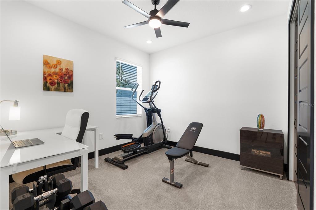 8756 Windlass Cove Palmetto, FL 34221 - Photo 31 of 50 a view of a workspace with furniture and gym equipment