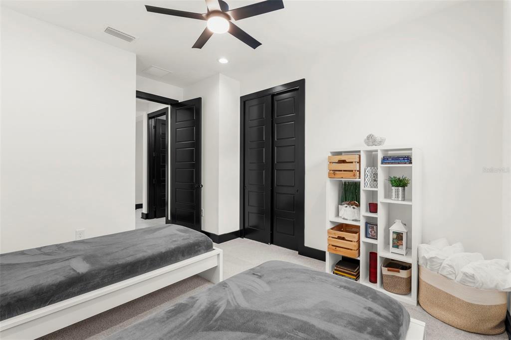 8756 Windlass Cove Palmetto, FL 34221 - Photo 36 of 50 a bedroom with a bed and a walk in closet