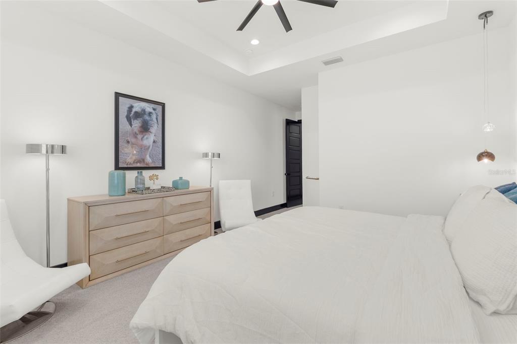 8756 Windlass Cove Palmetto, FL 34221 - Photo 45 of 50 a bed room with a bed and a chandelier