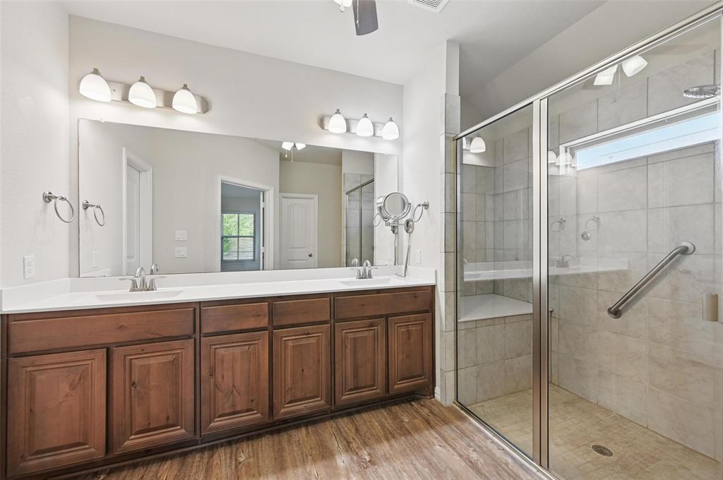 512 Hidden Spgs Trail Azle, TX 76020 - Photo 18 of 27 a spacious bathroom with a shower sink and mirror