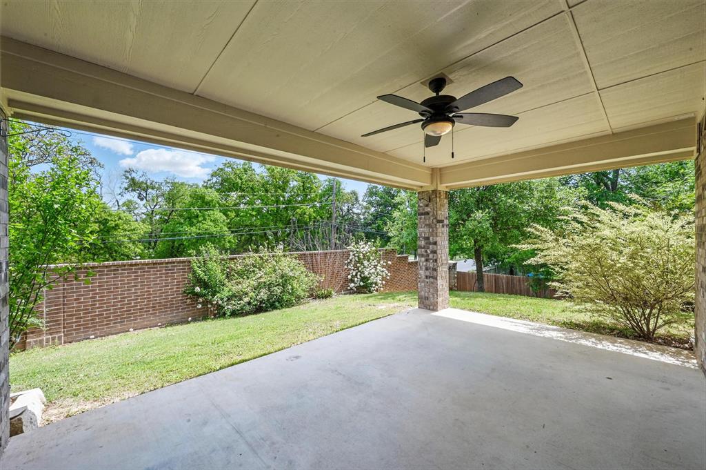 512 Hidden Spgs Trail Azle, TX 76020 - Photo 22 of 27 a view of a patio with a table and chairs under an umbrella