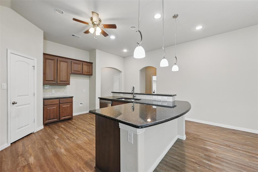 512 Hidden Spgs Trail Azle, TX 76020 - Photo 4 of 27 a kitchen with a sink a counter space cabinets and stainless steel appliances