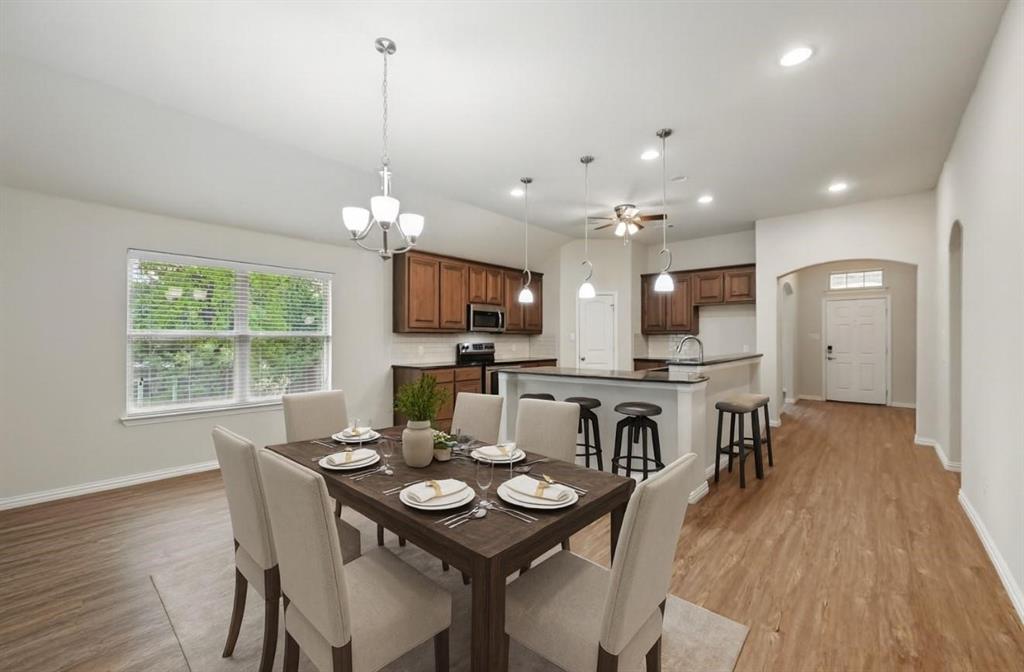512 Hidden Spgs Trail Azle, TX 76020 - Photo 6 of 27 a view of a dining room with furniture window and wooden floor