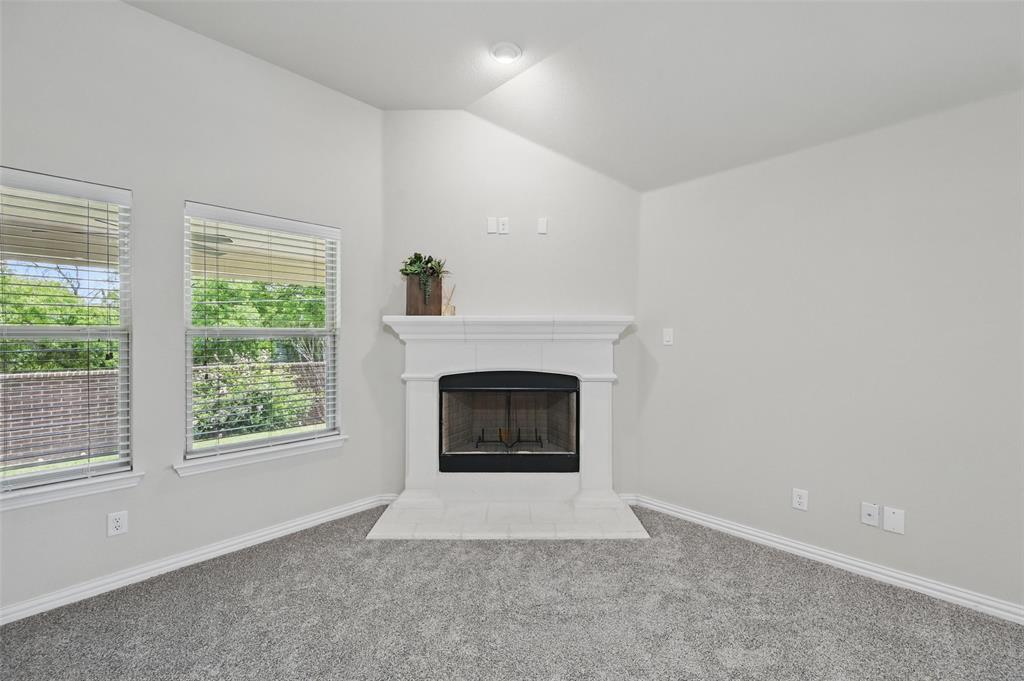 512 Hidden Spgs Trail Azle, TX 76020 - Photo 9 of 27 a living room with a fireplace and a window