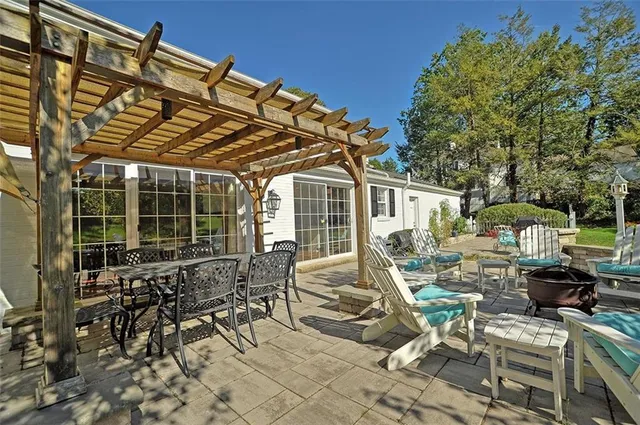 a view of a patio with table and chairs and potted plants