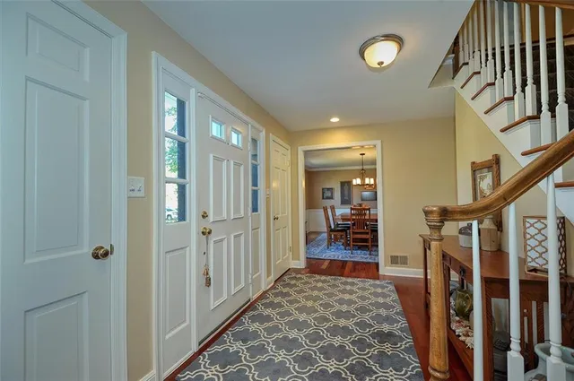 a view of a hallway to rooms and stairs