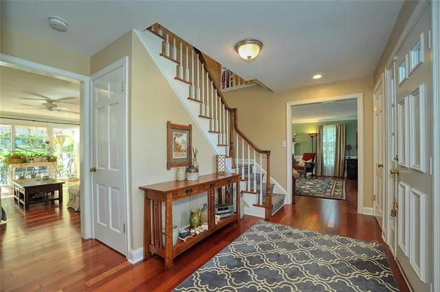 a view of an entryway wooden floor and windows