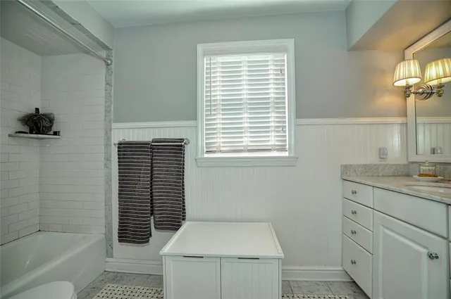 a bathroom with a granite countertop toilet a sink and a bathtub