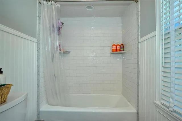 a bath tub sitting next to a white sink