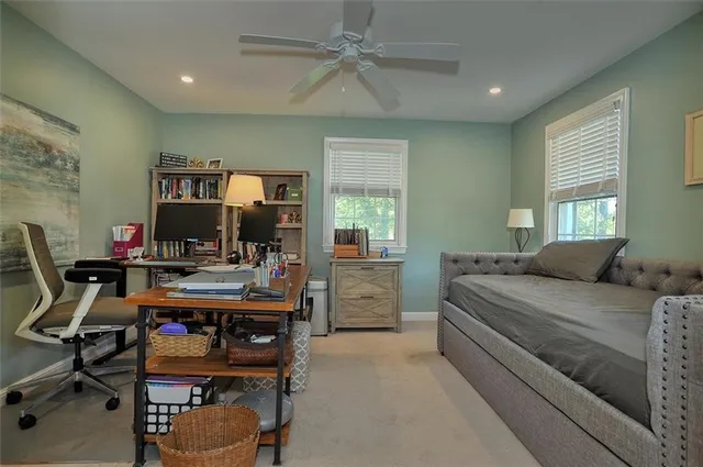 a bedroom with a bed and a desk