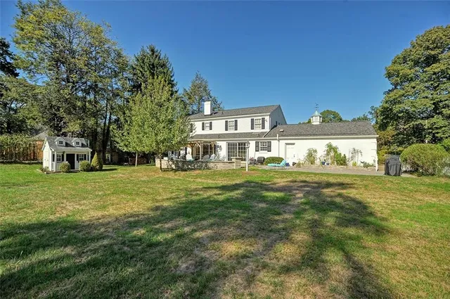 a front view of house with yard and trees