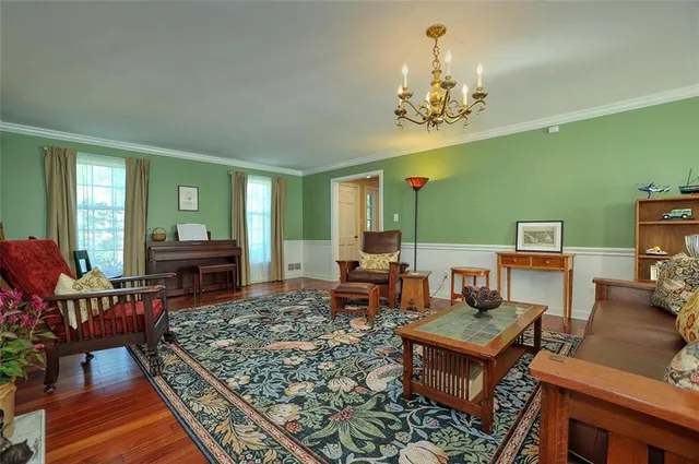a living room with furniture and a chandelier
