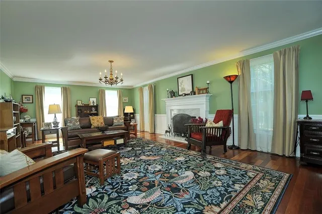 a living room with furniture and a chandelier