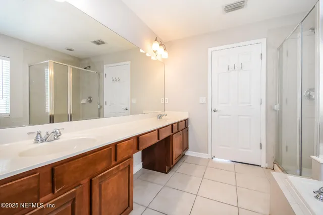 a spacious bathroom with a double vanity sink mirror and