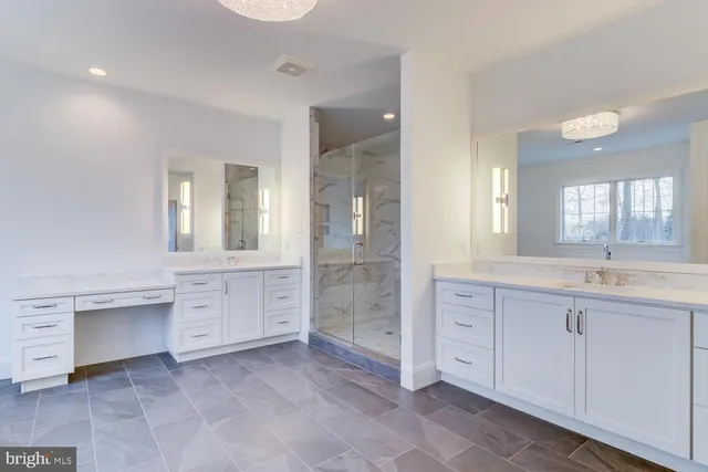 a spacious bathroom with a granite countertop sink mirror and