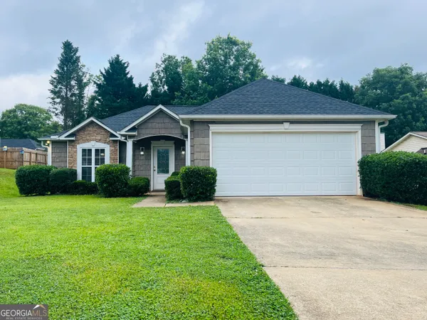 a front view of a house with a yard