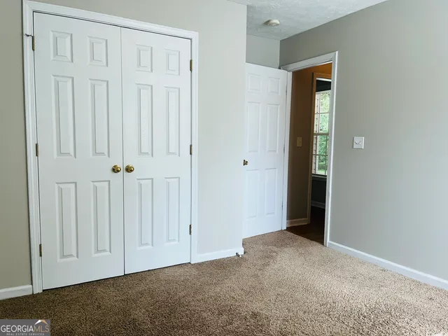an empty room with closet area