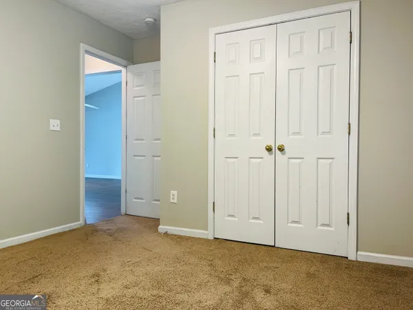 an empty room with closet area