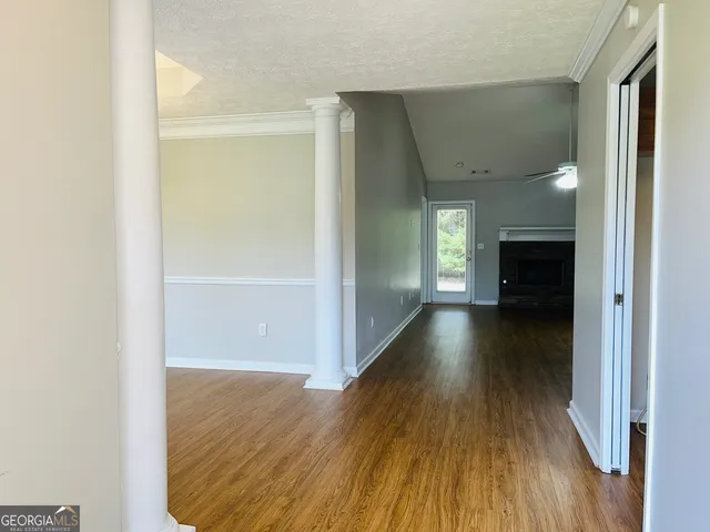 a view of a hallway view with wooden floor and staircase