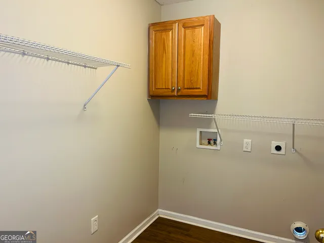 a view of a small room with wooden floor and a window