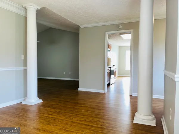 a view of a hallway with wooden floor