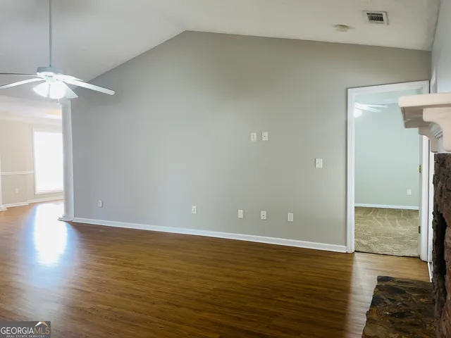 a view of a room with wooden floor and staircase