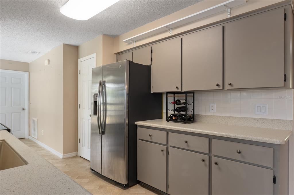 2481 South Summerwood Point Inverness, FL 34450 - Photo 15 of 38 a kitchen with a refrigerator and cabinets