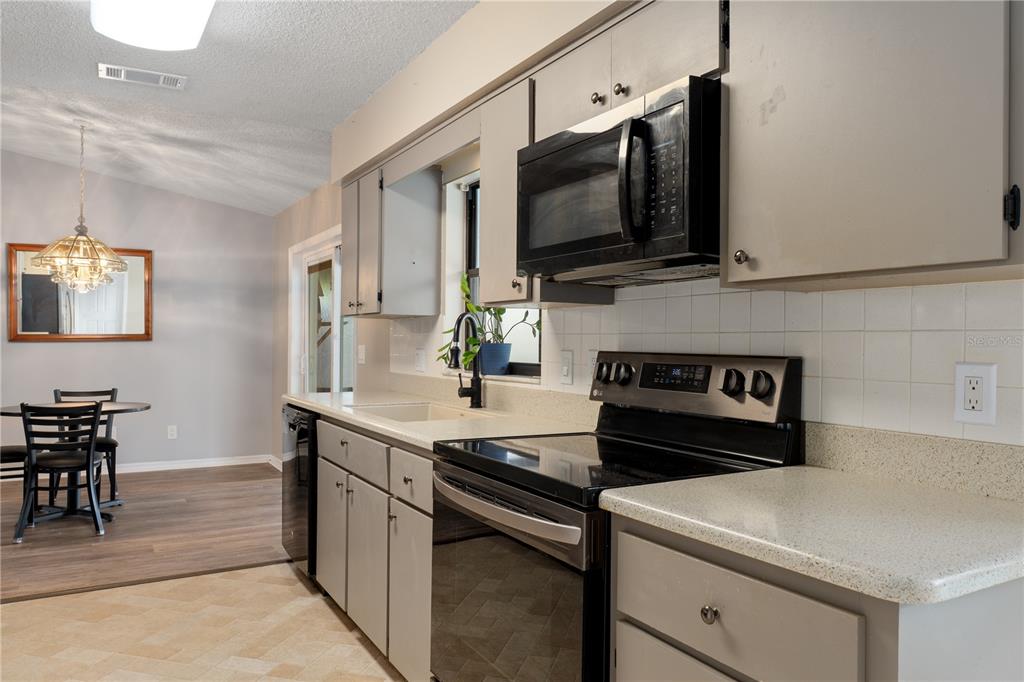 2481 South Summerwood Point Inverness, FL 34450 - Photo 16 of 38 a kitchen with a stove and a microwave