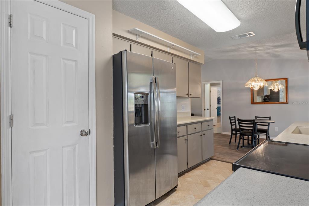 2481 South Summerwood Point Inverness, FL 34450 - Photo 17 of 38 a kitchen with stainless steel appliances a refrigerator and cabinets