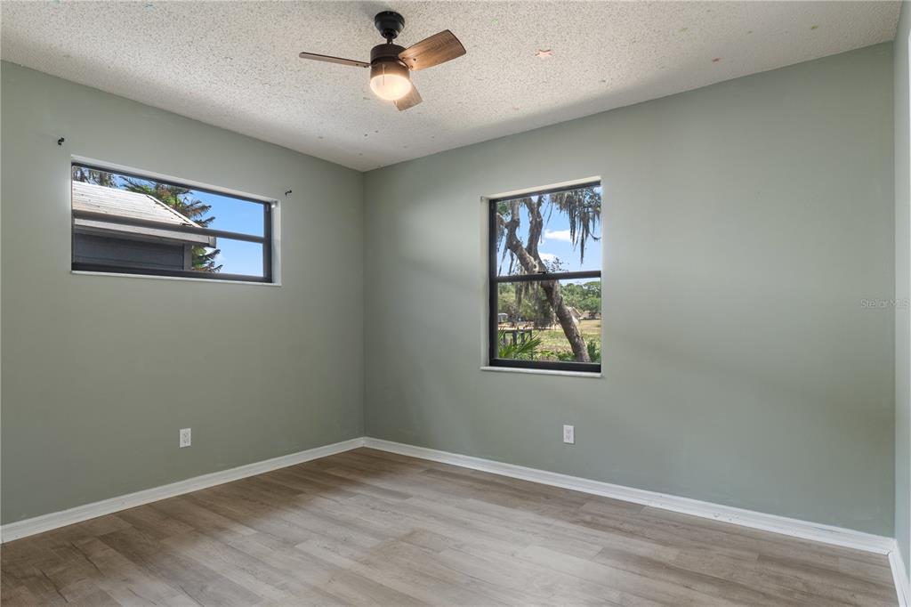 2481 South Summerwood Point Inverness, FL 34450 - Photo 18 of 38 an empty room with windows and fan