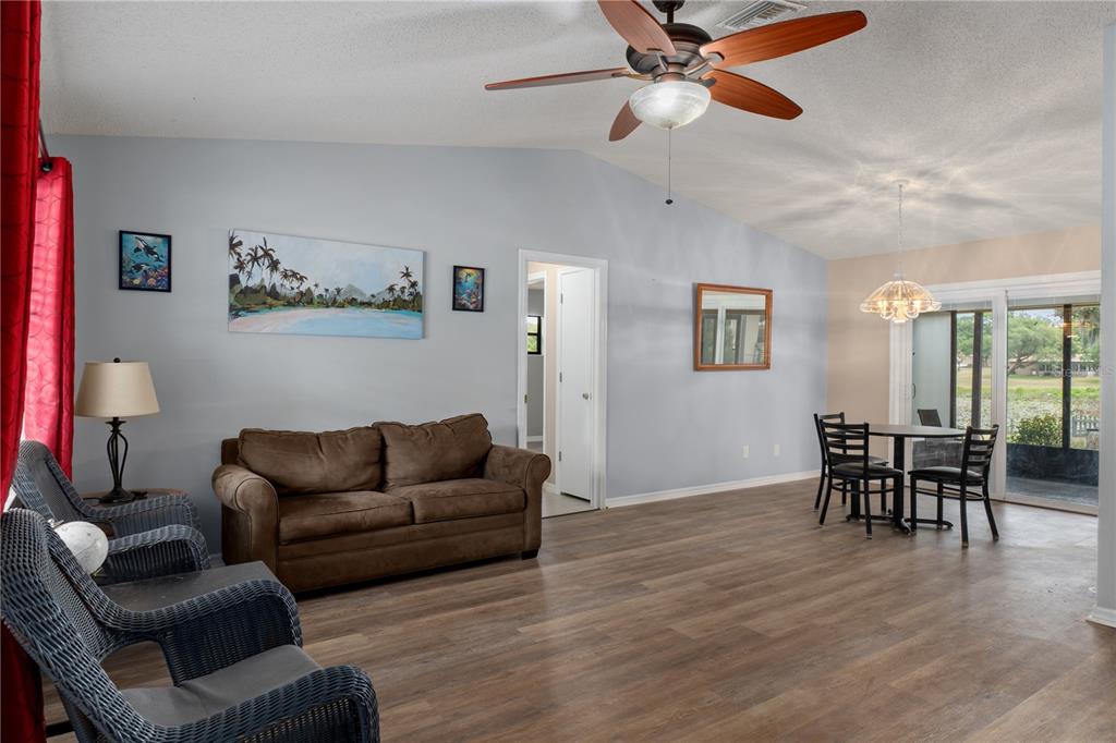 2481 South Summerwood Point Inverness, FL 34450 - Photo 7 of 38 a living room with furniture and a dining table with wooden floor