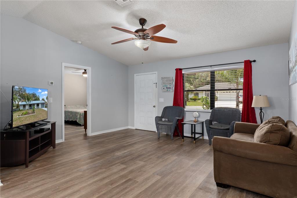 2481 South Summerwood Point Inverness, FL 34450 - Photo 10 of 38 a living room with furniture and a window