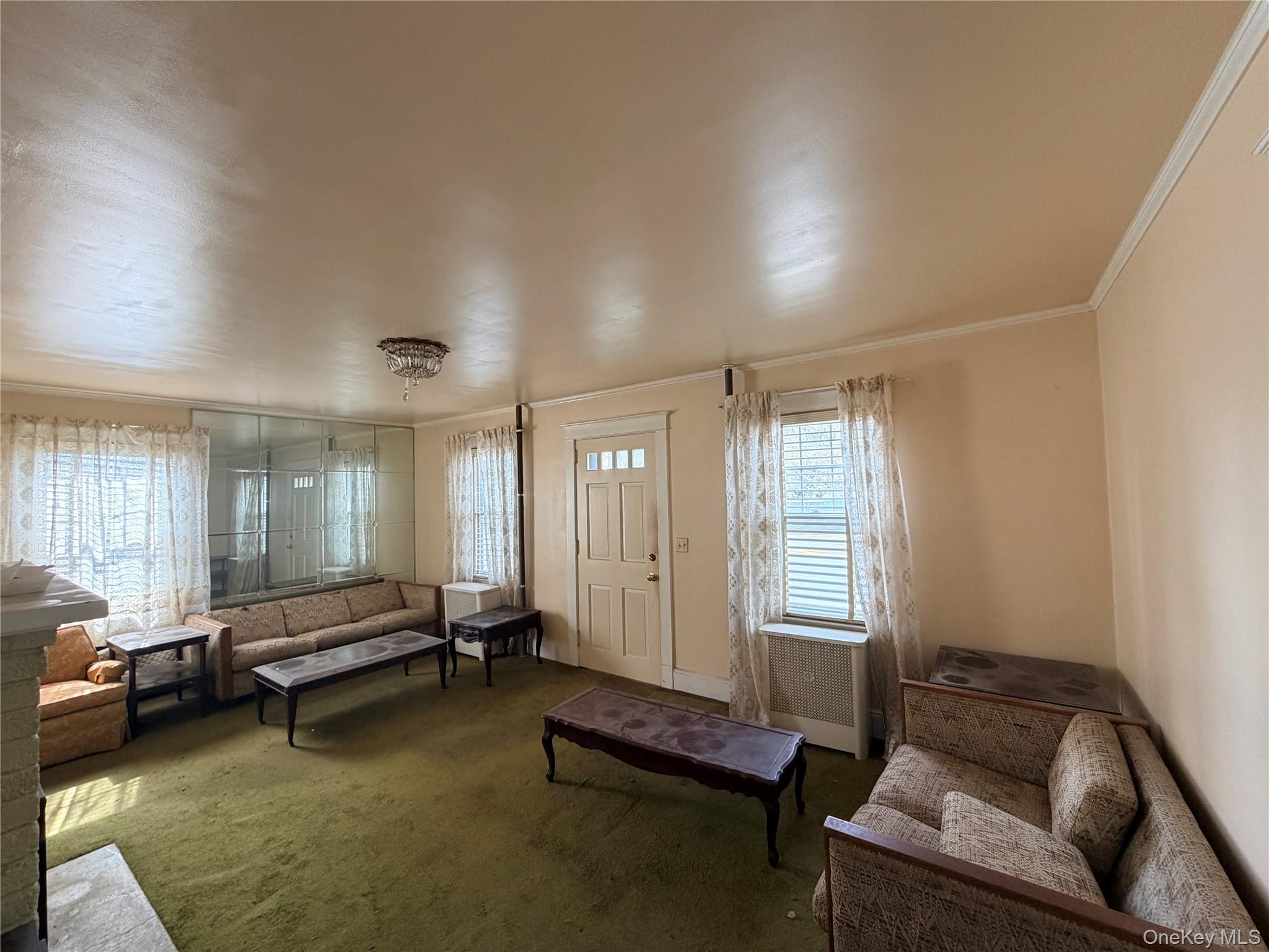 245 Woodbury Road Hicksville, NY 11801 - Photo 11 of 37 a living room with furniture and a window
