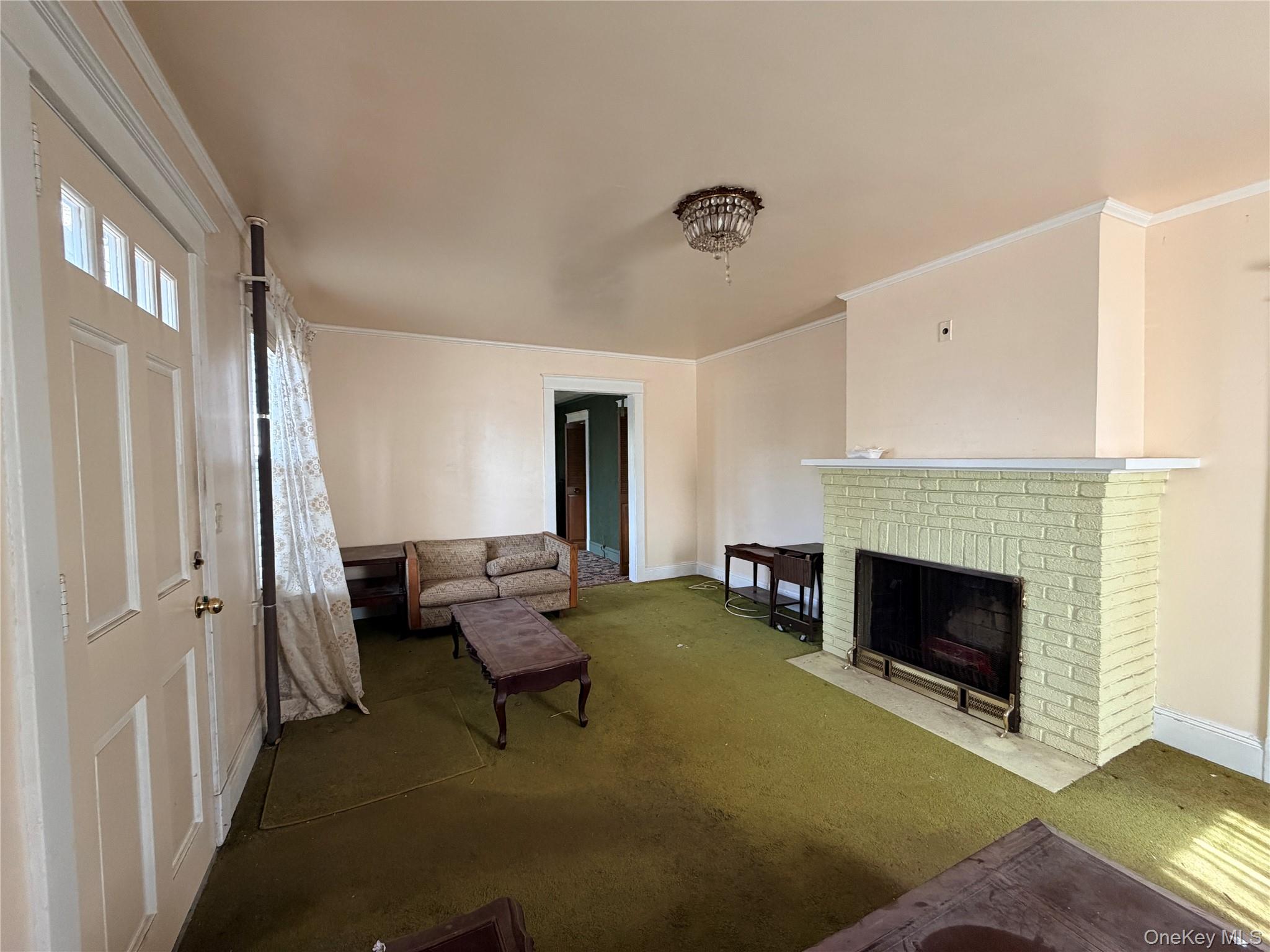 245 Woodbury Road Hicksville, NY 11801 - Photo 12 of 37 a living room with furniture and a fireplace