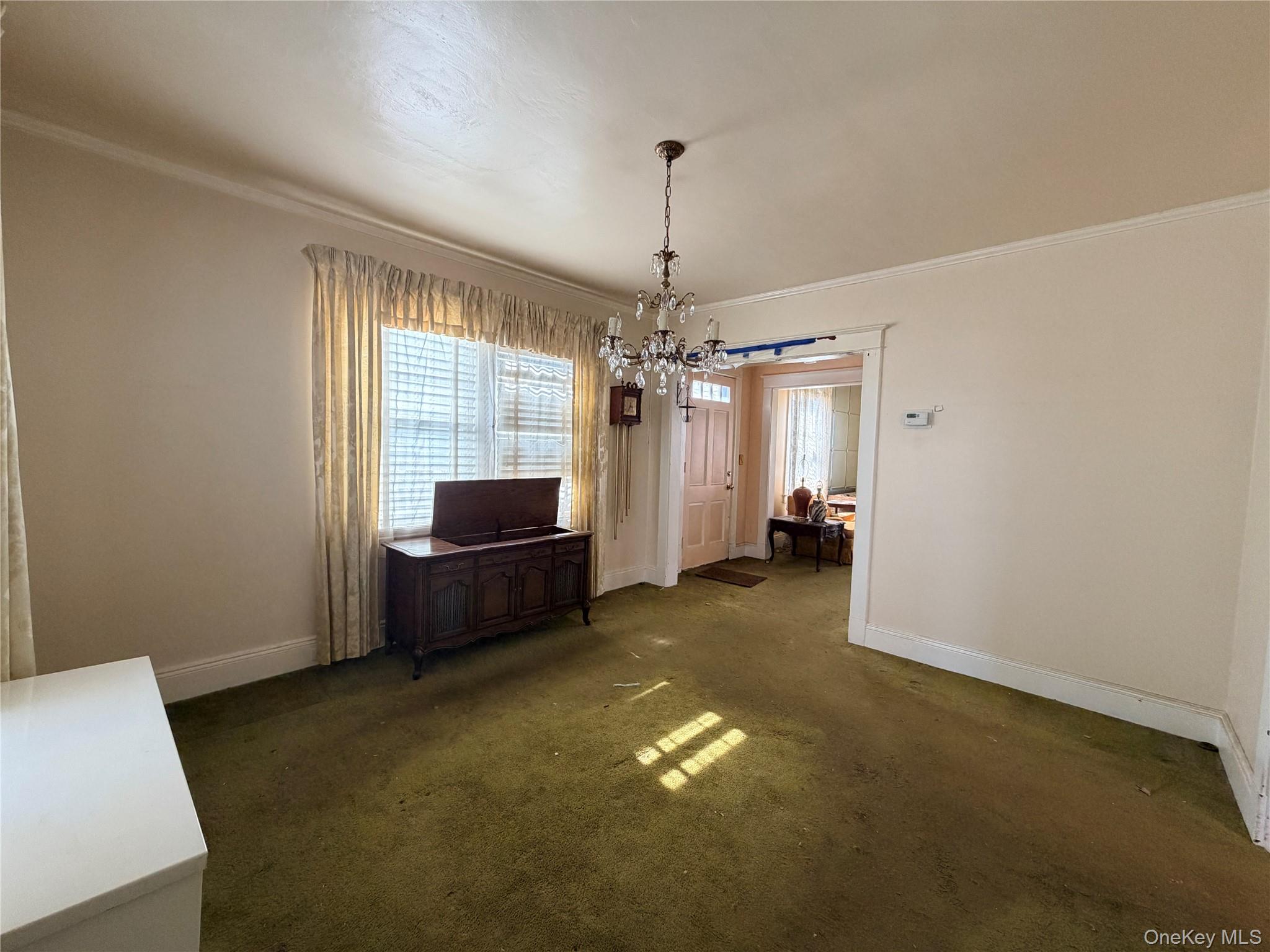245 Woodbury Road Hicksville, NY 11801 - Photo 13 of 37 a living room with furniture and a chandelier